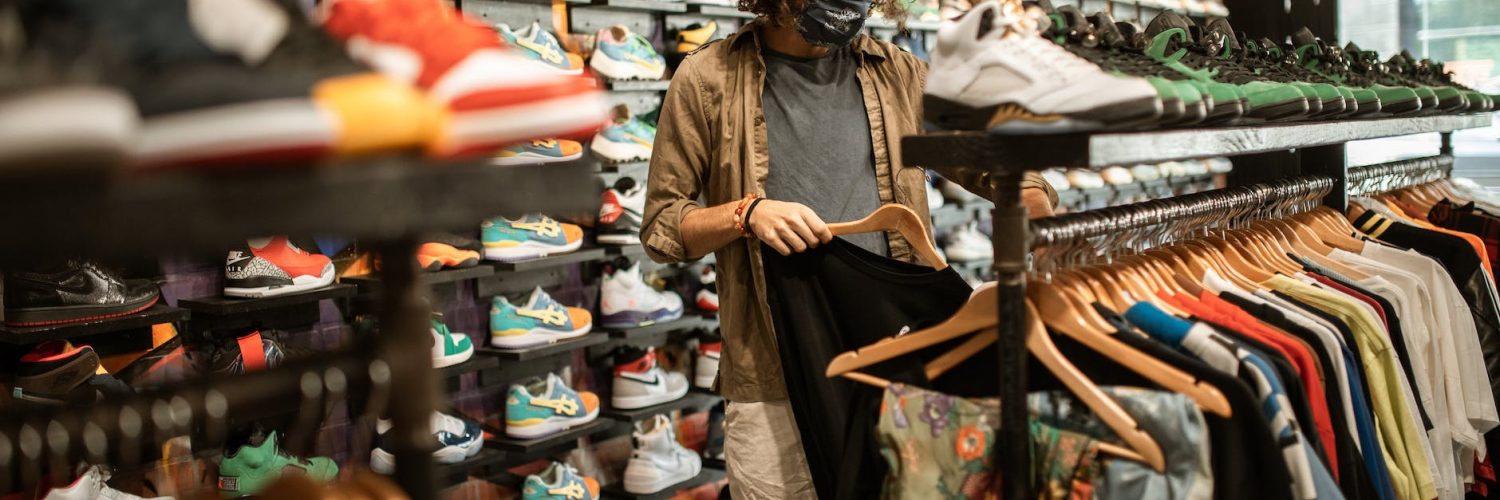 a man shopping for clothes at a sneaker shop
